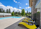 Thumbnail 29 of 47 - A pool with a yellow bench next to it.