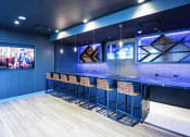 Thumbnail 19 of 31 - 3thirty3 new rochelle ny apartment high rise photo of sports pub area with bar seating and multiple televisions TVs and modern furniture and lighting