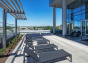 Thumbnail 27 of 31 - 3thirty3 new rochelle ny apartment high rise photo of outdoor lounge area with lounge seating and trellis and city views