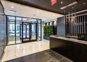 Thumbnail 11 of 31 - 3thirty3 new rochelle ny apartment high rise photo of main entrance lobby with concierge desk and modern finishes