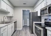 Thumbnail 1 of 19 - Rutland Place Apartments kitchen with stainless steel appliances and ample cabinet space, pet-friendly apartments in Macon, GA