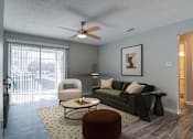 Thumbnail 6 of 19 - Rutland Place Apartments living room with large sliding door windows and ceiling fan, pet-friendly apartments in Macon, GA