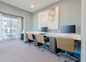 Thumbnail 5 of 22 - Resident business center with comfortable workstations at Sage 5430 apartments near Peachtree Corners, Georgia.