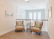 Thumbnail 19 of 22 - Resident sitting area with comfortable seating and natural light at Sage 5430 apartments near Historic Downtown Norcross.