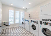 Thumbnail 4 of 22 - Convenient resident laundry facility with modern washers and dryers at Sage 5430 apartments in Gwinnett County.
