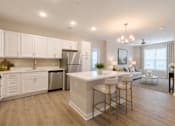 Thumbnail 1 of 22 - Open-concept one and two bedroom apartment with quartz countertops, stainless steel appliances, kitchen island, and spacious living area at Sage 5430 in Norcross, GA near Buford Highway and I-85.