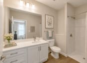 Thumbnail 9 of 22 - Modern apartment bathroom with large vanity, walk-in shower, and contemporary finishes at Sage 5430 in Norcross.