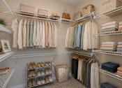 Thumbnail 8 of 22 - Spacious walk-in closet with built-in shelving and ample storage inside a Sage 5430 apartment home.