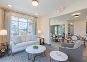 Thumbnail 11 of 22 - Comfortable resident lounge with natural light and inviting seating at Sage 5430 near The Forum Peachtree Corners.
