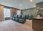 Thumbnail 2 of 22 - Resident media lounge with comfortable theater seating at Sage 5430, a welcoming 55+ apartment community in Norcross, Georgia.