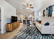 Thumbnail 6 of 32 - Bright and spacious living room with luxury vinyl plank flooring in a pet-friendly Santa Rosa Beach apartment.