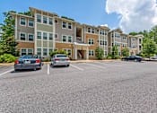 Thumbnail 29 of 32 - Community building exterior highlighting the luxury apartment complex in Santa Rosa Beach
