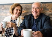 Thumbnail 17 of 18 - Happy senior couple relaxing with coffee at Sage 5430 pet-friendly 55+ apartments in Norcross, GA