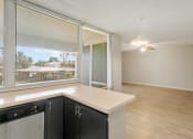 Thumbnail 6 of 18 - an open kitchen and living room with a large window