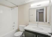Thumbnail 9 of 18 - a bathroom with a sink toilet and a mirror