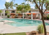 Thumbnail 10 of 18 - Tempe, AZ Apartments – Sentry Tempe – a swimming pool with trees and a building in the background