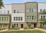 Thumbnail 35 of 39 - A modern building with a mix of beige and white exterior walls.