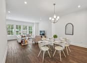 Thumbnail 6 of 39 - A dining room with a glass table and white chairs.