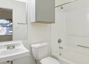Thumbnail 11 of 19 - Affordable Apartments for Rent in Austin, TX 78724 – Huntington Meadows – A white bathroom with a toilet, sink, and bathtub.