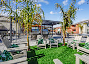 Thumbnail 4 of 25 - A sunny day at the outdoor seating area with green grass and trees.
