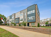 Thumbnail 34 of 39 - A modern building with a flag on the left side.