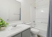 Thumbnail 14 of 19 - Pet-Friendly Apartments in Austin, TX – Huntington Meadows – A white bathroom with a sink, toilet, and bathtub.