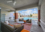 Thumbnail 16 of 25 - A patio with a pool table and chairs.