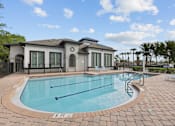 Thumbnail 4 of 28 - A small pool in front of a house.