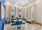 Thumbnail 3 of 28 - A dining room with a blue table and chairs.
