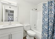 Thumbnail 28 of 46 - A white bathroom with a sink, toilet, and bathtub.