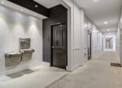 Thumbnail 14 of 19 - Sky Harbor Apartments in Chamblee, GA photo of a a hallway of elevators and doors in the clubhouse