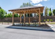 Thumbnail 15 of 19 - Sky Harbor Apartments in Chamblee, GA photo of a pavilion with a grill and picnic tables