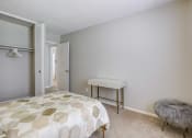 Thumbnail 8 of 15 - a bedroom with a bed and a desk