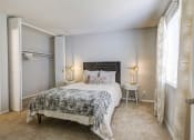Thumbnail 5 of 15 - a bedroom with a bed and two windows