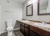 Thumbnail 6 of 15 - a bathroom with a toilet sink and mirror