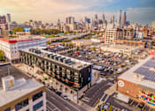 Thumbnail 28 of 29 - A cityscape with a Target store in the foreground.