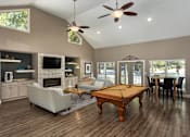Thumbnail 4 of 14 - Clubhouse with billiards table and lounge area in Stockbridge GA apartment community