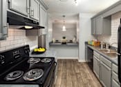 Thumbnail 5 of 14 - Kitchen and living room apartment in Stockbridge GA with wood-style flooring and natural light