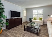 Thumbnail 6 of 14 - Spacious living room apartment in Stockbridge GA with large windows and comfortable layout at Southwinds Point