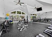 Thumbnail 14 of 18 - Fitness center with strength and cardio equipment at Southwinds Point Apartments in Stockbridge, GA.
