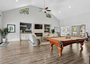 Thumbnail 16 of 18 - Resident clubhouse with billiards table and gathering space at Southwinds Point Apartments in Stockbridge, GA.