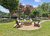 Thumbnail 12 of 18 - Outdoor fire pit and seating area at Southwinds Point Apartments, a pet-friendly community in Stockbridge, GA.