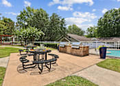 Thumbnail 13 of 18 - Outdoor grilling station and picnic area at Southwinds Point Apartments in Henry County, Georgia.