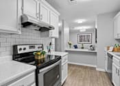 Thumbnail 2 of 18 - Updated apartment kitchen with ample cabinet space at Southwinds Point Apartments near Atlanta.