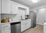 Thumbnail 3 of 18 - Updated apartment kitchen with ample cabinet space at Southwinds Point Apartments near Atlanta.