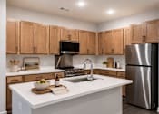 Thumbnail 1 of 23 - Gourmet apartment kitchen with stainless steel appliances, large island and modern cabinetry at Springview Apartments Decatur GA.