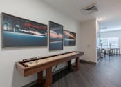Thumbnail 14 of 23 - Resident game room with suffleboard table and lounge seating at Springview Apartments in Decatur near South DeKalb.
