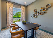 Thumbnail 16 of 23 - Community business center with private workspaces and modern seating at Springview Apartments near Panthersville Road.