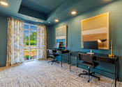 Thumbnail 17 of 23 - Resident coworking lounge with modern workstations inside Springview Apartments in Decatur, Georgia.