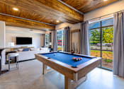Thumbnail 3 of 23 - Clubhouse game room with billiards table and gathering space at Springview Apartments near Panthersville Road.